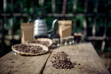 Arabica Coffee bean and coffee bag and traditional brewing coffee maker on wooden table