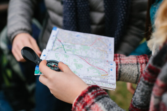 Friends use map and compass outdoors
