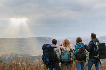 Friends are enjoying sunny autumn weather while hiking in the mountains