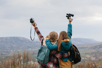 Friends are enjoying sunny autumn weather while hiking in the mountains