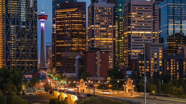 Day to night timelapse sequence showing traffic and modern landmark buildings in Downtown Calgary, Alberta, Canada. 