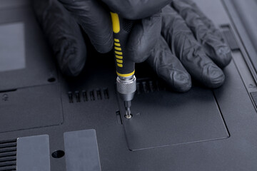 close up view for a technician worker repairing or adjusting laptop pc. person using work tool to open memory module socket. laptop and computer service conceptual