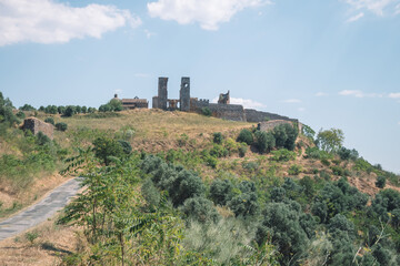 Fototapeta na wymiar large castle ruins on top of a mountain.
