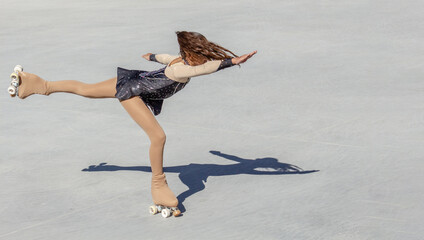Teenage girl performing figure skating on wheels