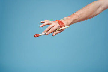 Artists hands paint close-up blue background drawing hobby