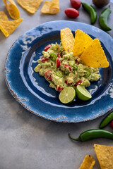 Fresh Guacamole with Ingredients and Tortilla Chips. Traditional Mexican Food. Top View.