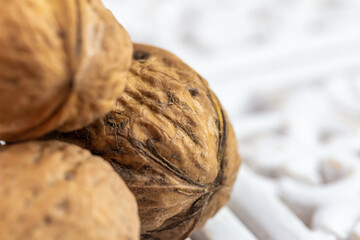 Walnuts on white glass stand