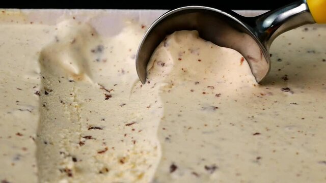 Slow motion Close up Ice cream Chocolate Chip scooped out from container with a spoon, Food concept.