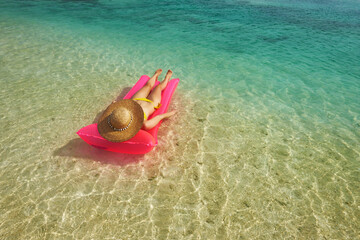 Woman relaxing on inflatable mattress