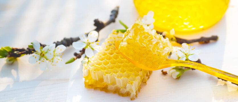 broken yellow fresh honeycomb with honey on table. Honey products. healthy natural food concept. Selective focus
