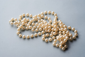 Pearl beads on a gray background decoration decoration top view
