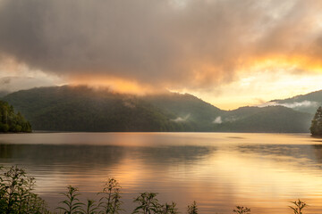 Beautiful sunset behind mountains on a lake in the Smokies in North Carolina