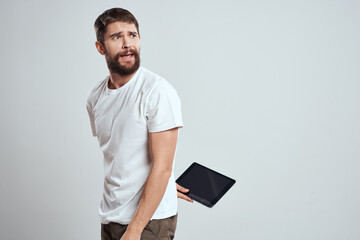 emotional man with tablet in hand touch screen new technologies light background cropped view Copy Space
