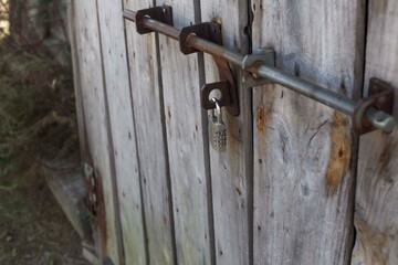 old wooden textured door with latch and lock.