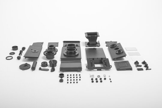 A Completely Deconstructed Knolling Style View Of A Vintage Twin-lens Camera On White Background