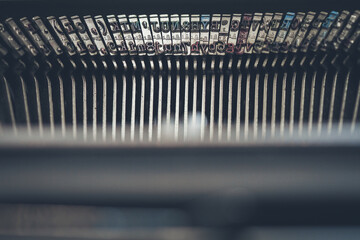Fototapeta premium The letter arms inside of a vintage retro style typewriter 1