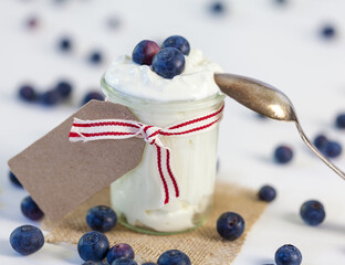 Jar of clotted cream or yogurt with blueberries