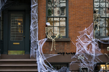 Spooky and scary front house decoration for Halloween with spiderwebs and skeletons
