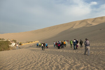 group of people walking on the beach