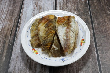 Deep fried gourami fish meat without bone on the plate. Famous appetizer and side dish seafood menu in Asia restaurant. 