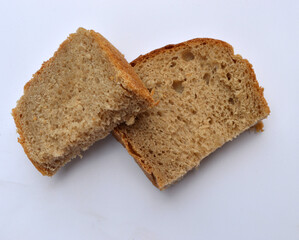 two slices of sliced ​​bread lies on a white background
