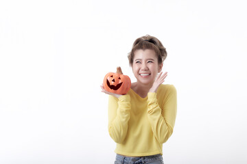 Young woman holding a pumpkin in halloween on white