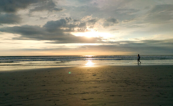 A woman taking picture from the beauty of Petitenget beach Bali Indonesia.
