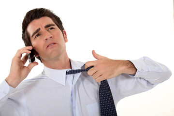 Man undoing his tie.