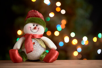Christmas scene: snowman with background of out-of-focus colored lights