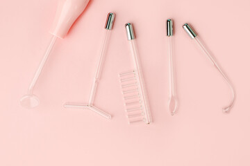 Darsonval on a pink background. Top view mockup with space for text. Darsonvalization. Cosmetology. Microcurrent therapy, wellness, self care concept, beauty routine for skin, body and hair