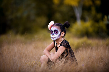 Asian girl sugar skull facepaint with flower on Halloween.
