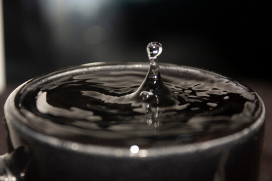 High Speed Frozen Splash Of Liquid Emerging From Depth In Clean Water Without People