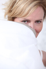 Wife behind pillow