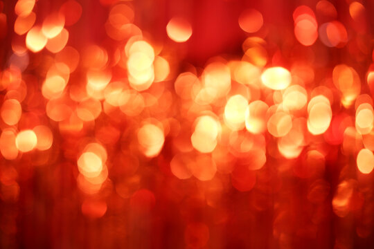 Defocused abstract christmas with red and gold Sparkling Lights Festive background with texture.
