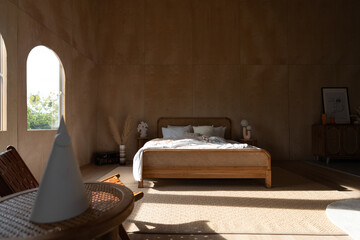 Stylish Bedroom corner with rattan headboard and bed with soft pillows setting with white pillows...