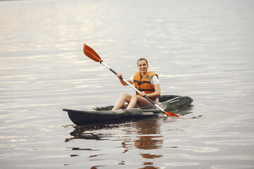 Kayaking. A woman in a kayak. Girl paddling in the water.