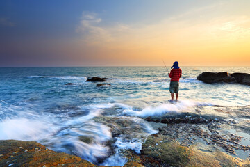 Man fishing at sunset in Rayong, Thailand

