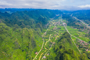 aerial view of cityscape and nature with green fields and mountains in Chi Lang, Lang Son, Vietnam.