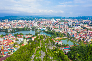 Naklejka na ściany i meble Aerial landscape: Ancient wall of The Mac dynasty as known as Northern Mac or House of Mac, old ruins located on a mountain with panoramic city Lang Son backwards, Vietnam.