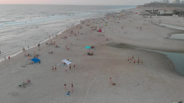 The beach of Netania Poleg Full of people drone shot