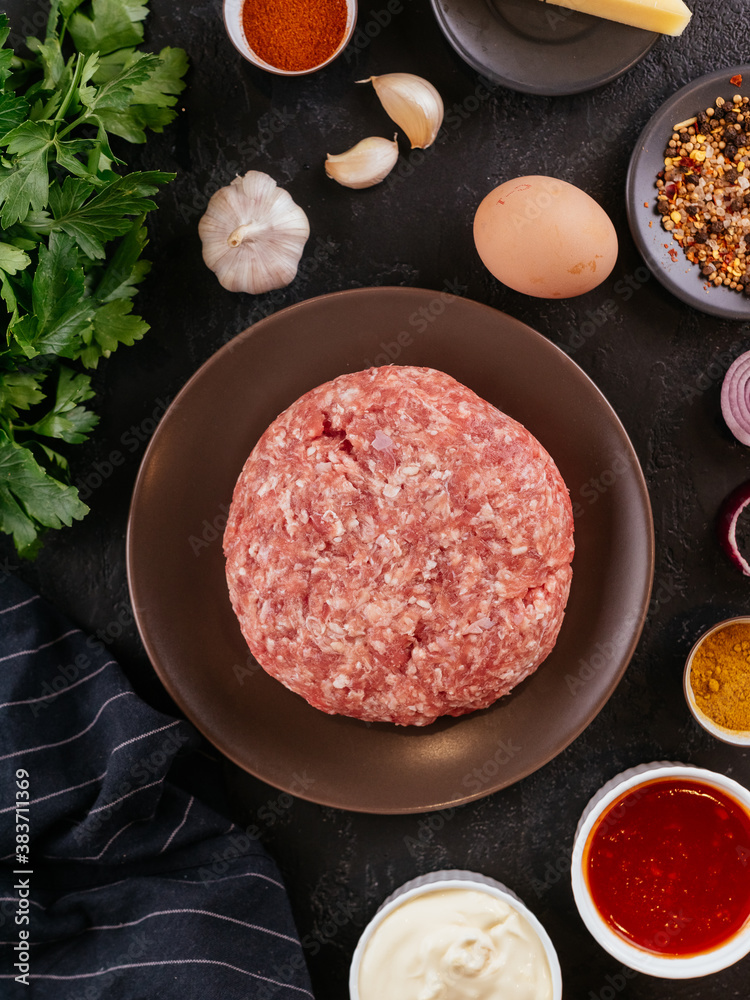 Canvas Prints fresh raw minced pork in a wooden bowl with vegetables on the ba