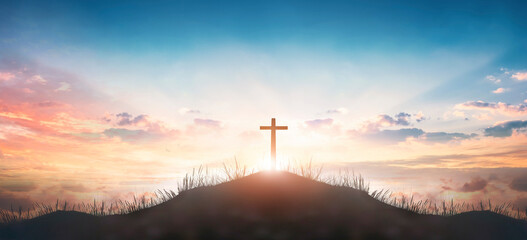 Christian concept: Silhouette cross on  mountain sunset background