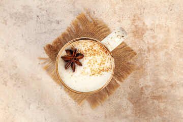 Fototapeta na wymiar Latte coffee cup with milk froth on vintage background