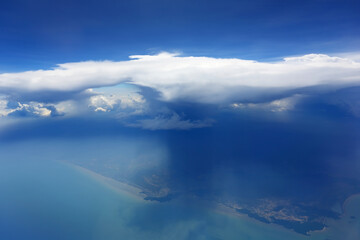 Fototapeta na wymiar Cloudy blue sky view from airplane window