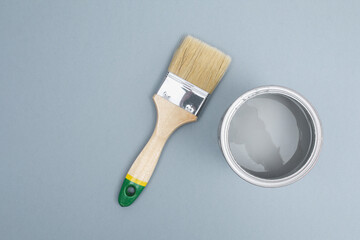 Open paint enamel cans on gray palette samples.