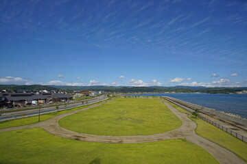 Green park near sea front with ocean on the background. Toyama, Japan.