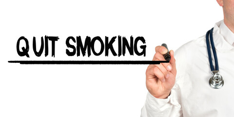 Doctor writes the word - QUIT SMOKING. Image of a hand holding a marker isolated on a white background.