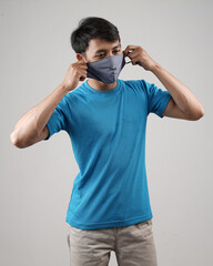 Young men in empty T-shirts and wearing health masks, dress up and pose like famous T-shirt models. Men's t-shirt template and mockup design for print.