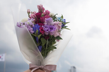 Beautiful pink, purple Lisianthus bouquet in full bloom with green leaves.