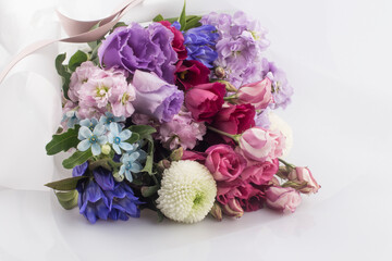 Beautiful pink, purple Lisianthus bouquet in full bloom with green leaves.